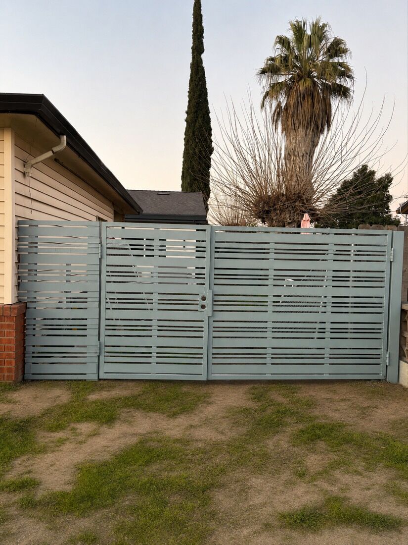 Powder-coated horizontal-slat metal gate in a soft sage finish